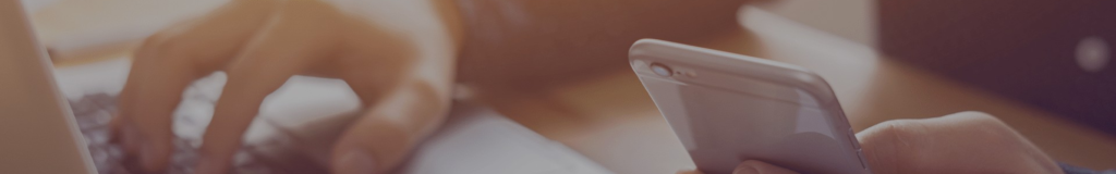 Close-up of a white spoon with a drop of liquid on its tip.