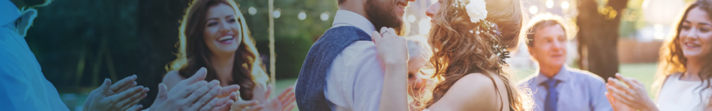 Man with a beard adjusting his vest outdoors.