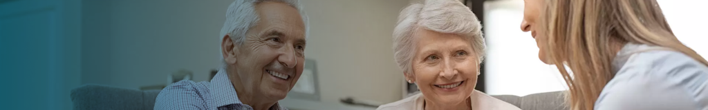 Smiling elderly couple enjoying a moment together indoors.