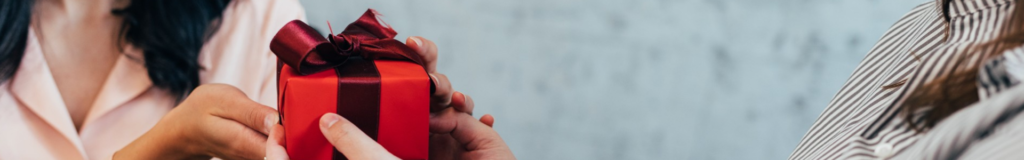 Person holding a black marker, writing on a transparent surface.