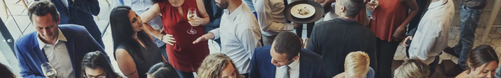 People engaged in conversation at a social or professional gathering.